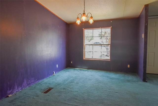 carpeted spare room with visible vents, ornamental molding, vaulted ceiling, a notable chandelier, and a textured ceiling