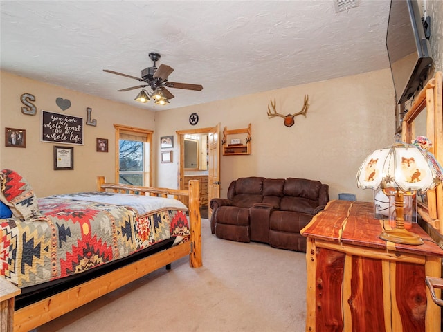 bedroom with visible vents, carpet, and a textured ceiling