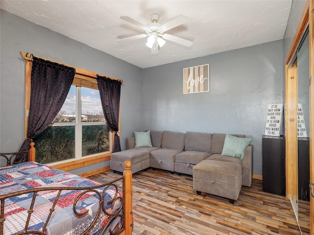 bedroom with wood finished floors and ceiling fan