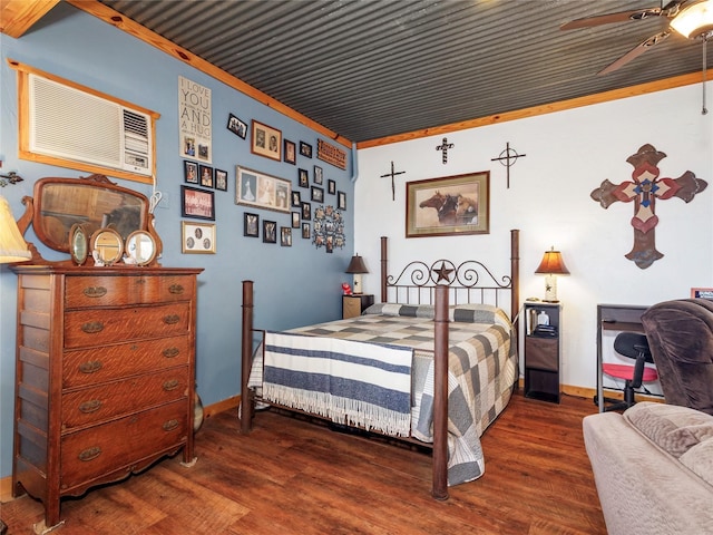 bedroom featuring crown molding, baseboards, and wood finished floors