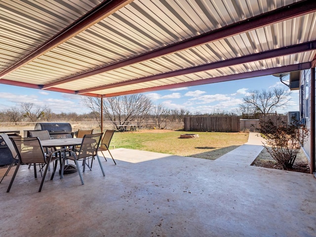 view of patio with area for grilling, outdoor dining area, a fire pit, and fence