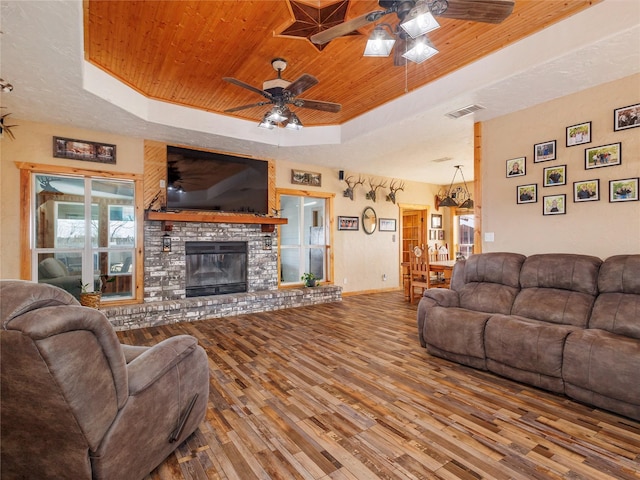 living room with visible vents, a raised ceiling, wood ceiling, and wood finished floors