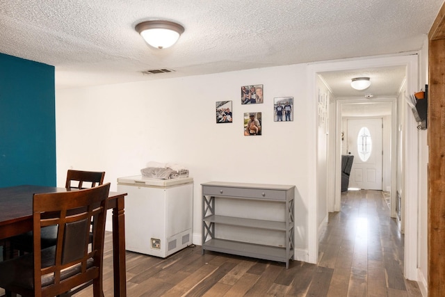 1719 E Bankhead Dr, Weatherford, TX 76086 - dining room featuring wood-type flooring, a textured ceiling, and baseboards