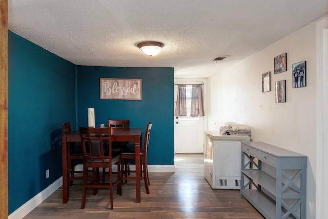 1719 E Bankhead Dr, Weatherford, TX 76086 - dining space featuring wood-type flooring, a textured ceiling, and baseboards