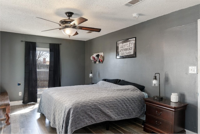 1719 E Bankhead Dr, Weatherford, TX 76086 - bedroom with wood finished floors, a textured ceiling, baseboards, and a ceiling fan