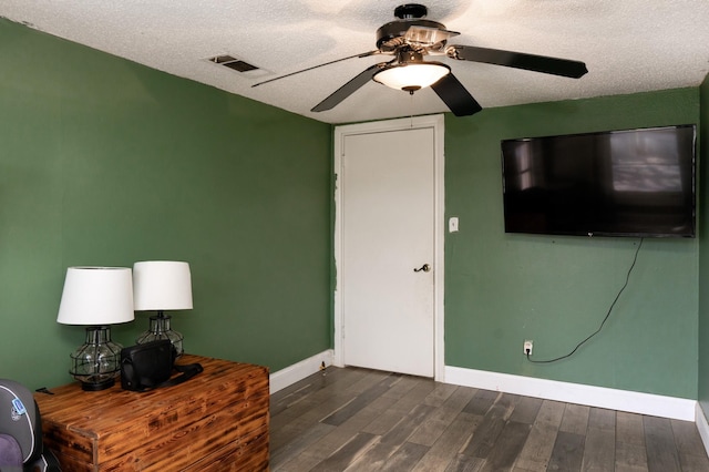 1719 E Bankhead Dr, Weatherford, TX 76086 - sitting room featuring dark wood-style flooring, ceiling fan, baseboards, and a textured ceiling