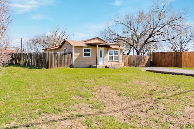 view of front of property with fence private yard and a front yard