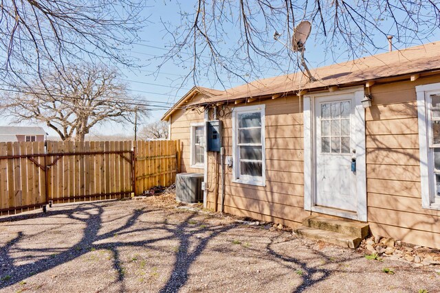 1719 E Bankhead Dr, Weatherford, TX 76086 - view of side of property featuring fence, entry steps, and central air condition unit