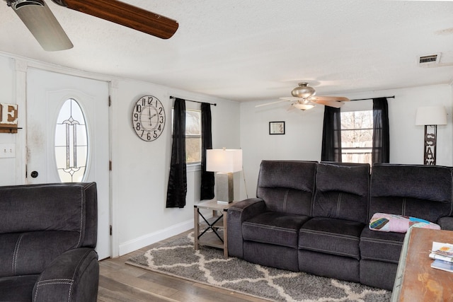 1719 E Bankhead Dr, Weatherford, TX 76086 - living room featuring a ceiling fan, wood finished floors, and baseboards
