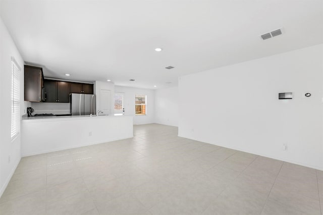 unfurnished living room with visible vents and recessed lighting