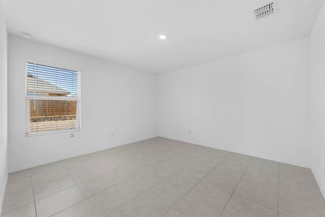 spare room with recessed lighting, visible vents, and baseboards