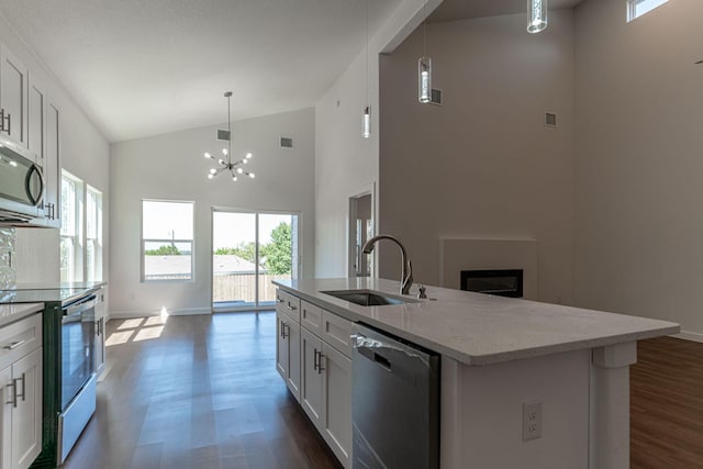 kitchen with visible vents, electric stove, a sink, stainless steel microwave, and dishwashing machine