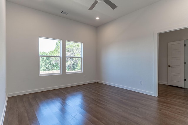 spare room featuring a ceiling fan, baseboards, visible vents, recessed lighting, and dark wood-type flooring