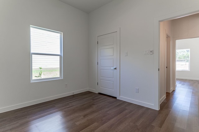 unfurnished bedroom featuring dark wood-type flooring and baseboards