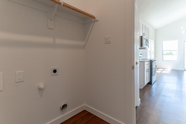 clothes washing area with electric dryer hookup, baseboards, dark wood finished floors, and laundry area