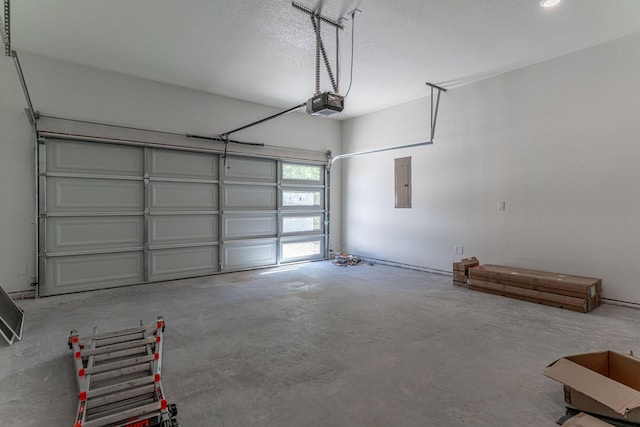 garage with electric panel and a garage door opener