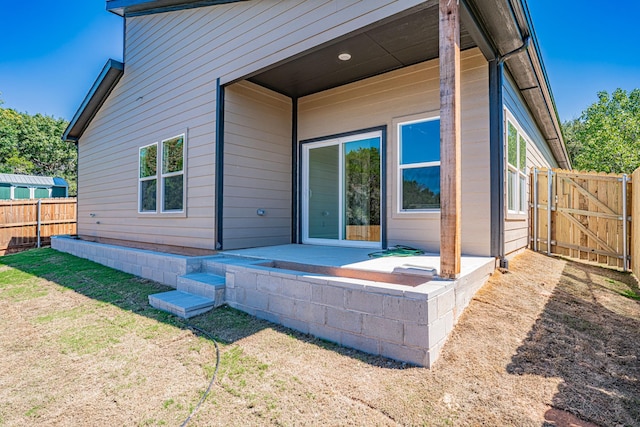 back of house with a gate, a patio, and fence