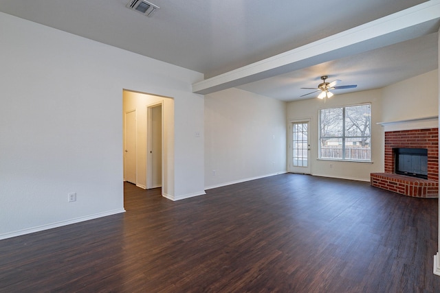 unfurnished living room featuring a ceiling fan, baseboards, visible vents, dark wood-type flooring, and a brick fireplace