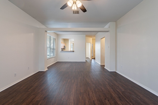 unfurnished room with visible vents, a ceiling fan, dark wood-type flooring, and baseboards