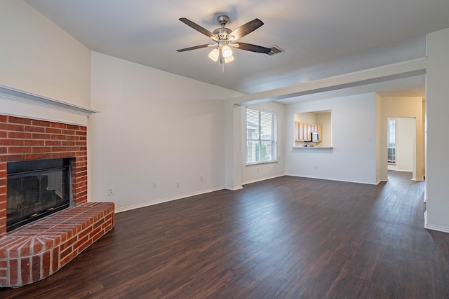 unfurnished living room with visible vents, a brick fireplace, dark wood-type flooring, and ceiling fan