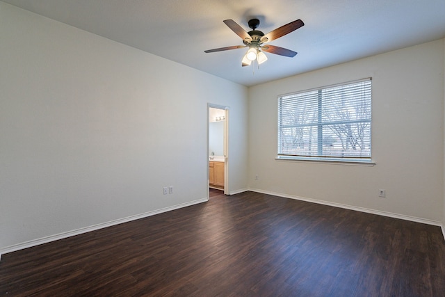 spare room featuring ceiling fan, baseboards, and dark wood-style flooring