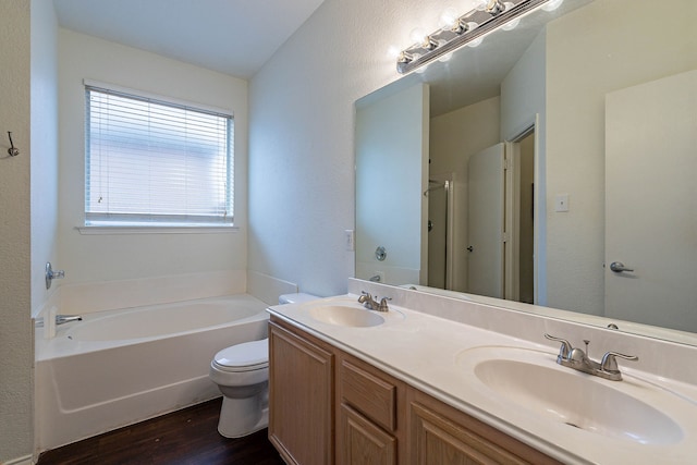 full bath featuring a sink, wood finished floors, a bath, and double vanity