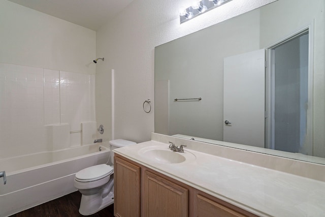 bathroom with vanity, wood finished floors, toilet, and tub / shower combination