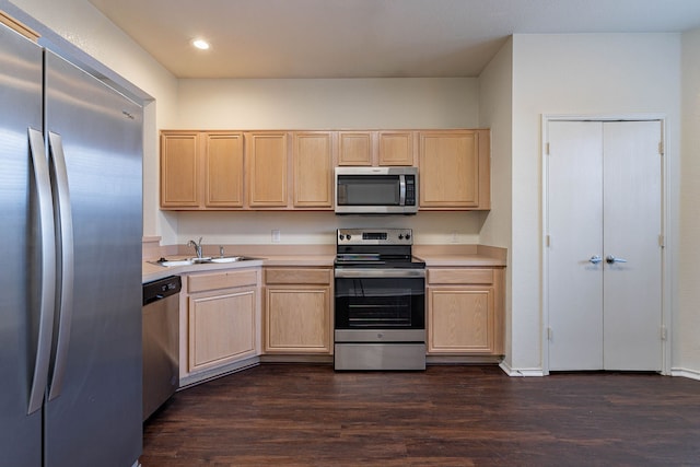 kitchen featuring light brown cabinetry, stainless steel appliances, light countertops, and a sink