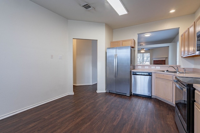 kitchen featuring dark wood-style flooring, appliances with stainless steel finishes, light countertops, and a sink