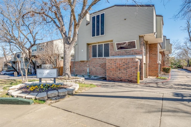 exterior space featuring brick siding