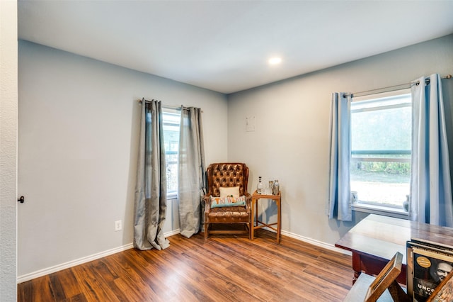 sitting room with baseboards and wood finished floors