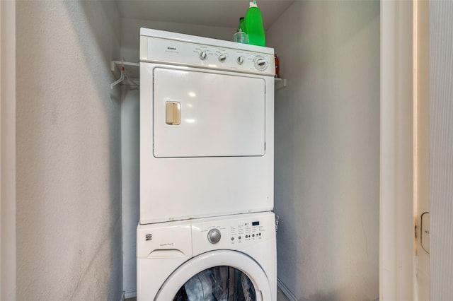 laundry room featuring laundry area and stacked washer / drying machine