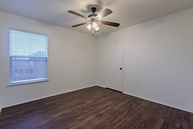 unfurnished room featuring ceiling fan, dark wood-style floors, baseboards, and a textured ceiling