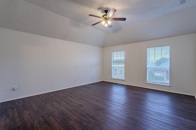 unfurnished room featuring baseboards, visible vents, dark wood finished floors, ceiling fan, and vaulted ceiling