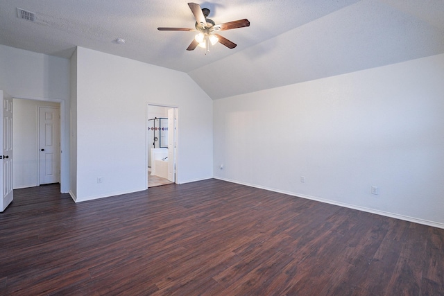 interior space with dark wood finished floors, visible vents, baseboards, and vaulted ceiling