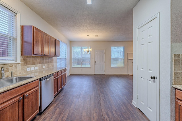 kitchen featuring an inviting chandelier, dark wood-style flooring, a sink, stainless steel dishwasher, and tasteful backsplash