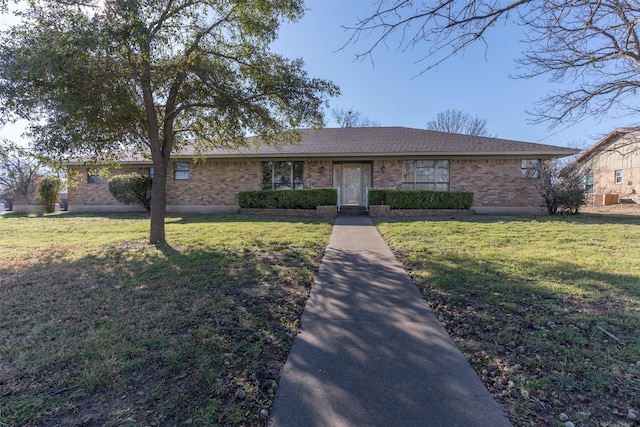 single story home with a front lawn, brick siding, and a shingled roof