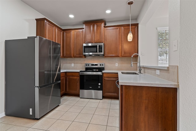 kitchen with light tile patterned flooring, appliances with stainless steel finishes, tasteful backsplash, and a sink