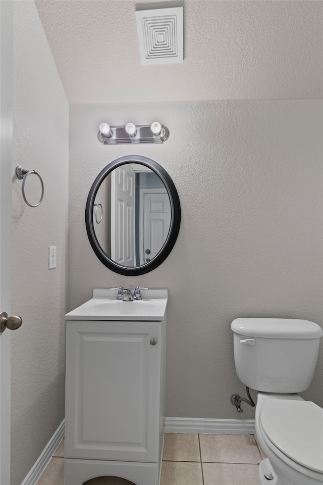 bathroom featuring tile patterned flooring, vanity, visible vents, and baseboards