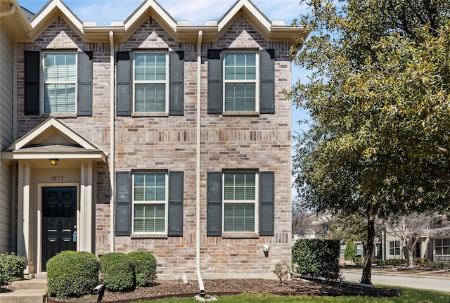 view of property featuring brick siding