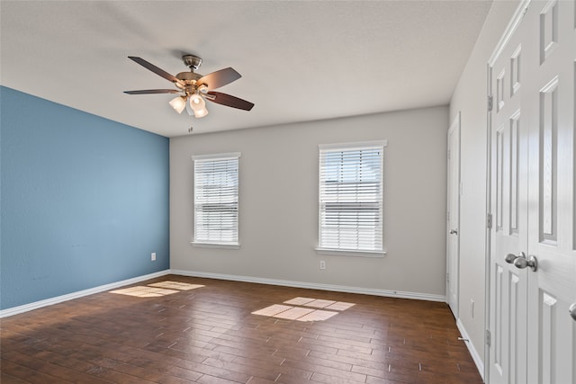 unfurnished bedroom with a ceiling fan, hardwood / wood-style flooring, baseboards, and a closet