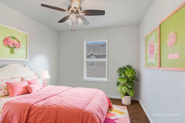 bedroom with baseboards, wood finished floors, and a ceiling fan