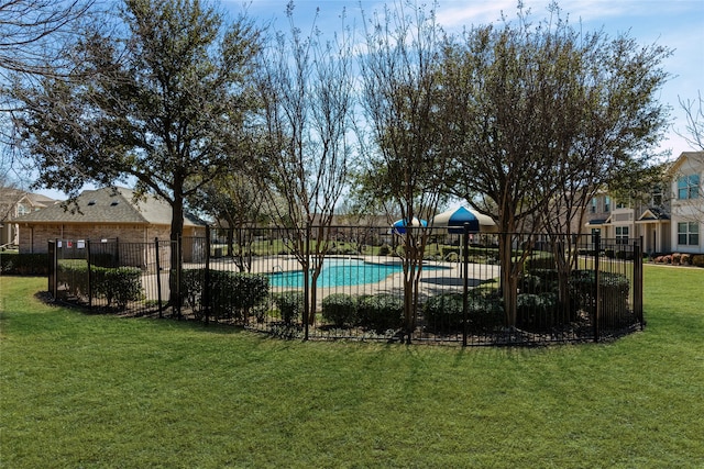 community pool with a lawn and fence