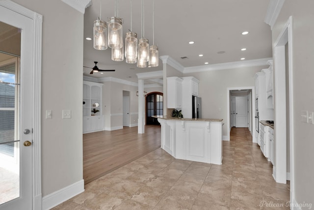 kitchen with light stone countertops, stainless steel fridge with ice dispenser, white cabinets, crown molding, and open floor plan