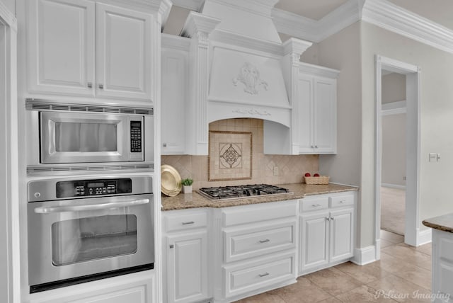 kitchen featuring white cabinetry, crown molding, light stone countertops, and stainless steel appliances