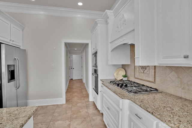 kitchen featuring tasteful backsplash, white cabinetry, stainless steel appliances, crown molding, and light stone countertops