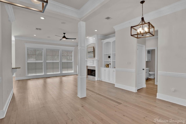 unfurnished living room featuring visible vents, light wood-style floors, a fireplace, and crown molding