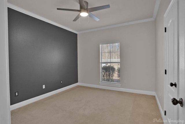 spare room with baseboards, light colored carpet, and ornamental molding