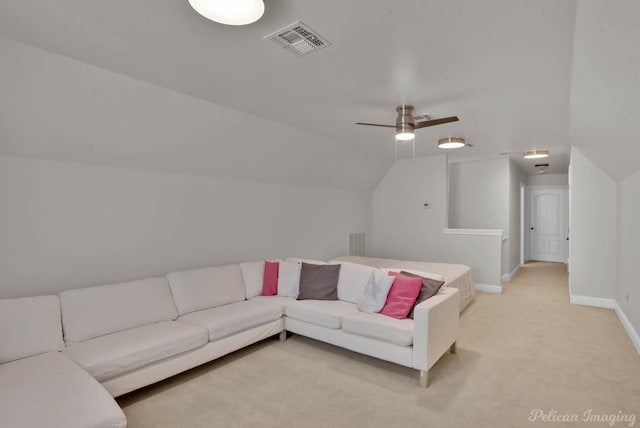 living area featuring visible vents, light carpet, baseboards, ceiling fan, and vaulted ceiling