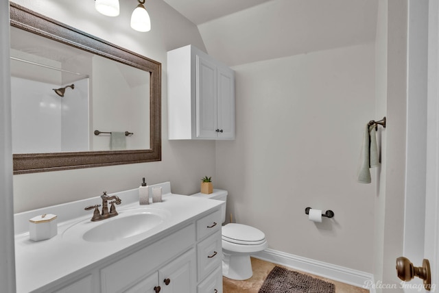 bathroom with vanity, toilet, and baseboards